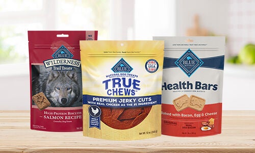 3 bags of dog treats, one red blue wilderness treats, one yellow True Chews, and one Health Bars